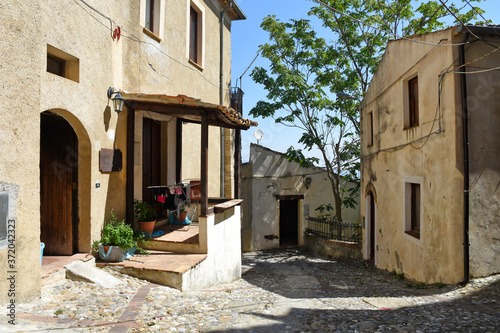 A narrow street among the old houses of Altomonte, a rural village in the Calabria region. photo