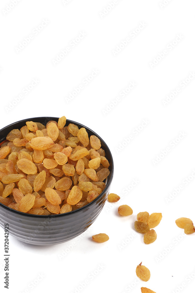 Bowl with dried golden raisins isolated on white. Dried Grapes. Bowl with dried golden raisins isolated on white. Dried Grapes.