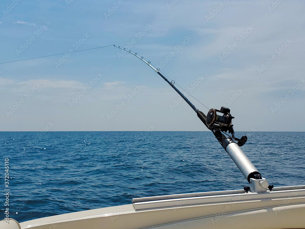 fishing rod in pole holder on boat Stock Photo