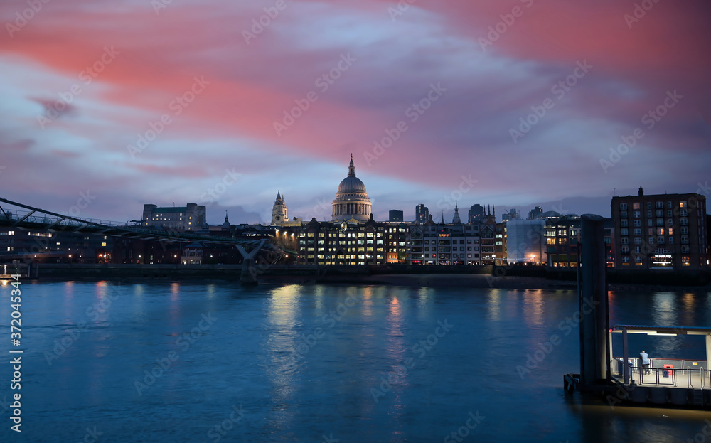 A view across the River Thames at dusk towards St. Paul's Cathedral in London, UK.