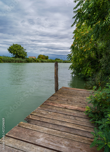 Lagoon landscape with wild nature  wooden jetty and blue sky