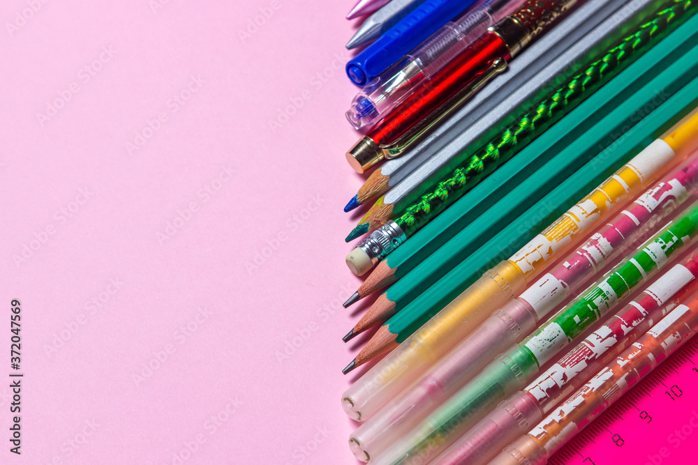Fototapeta premium School supplies. Education concept. Stationery. There is a place for an inscription or logo. Photo on a pink background