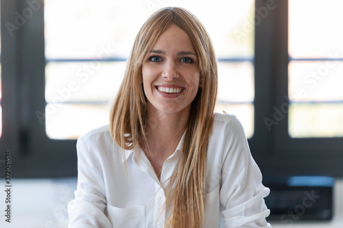 Pretty young woman blogger smiling while making social media video