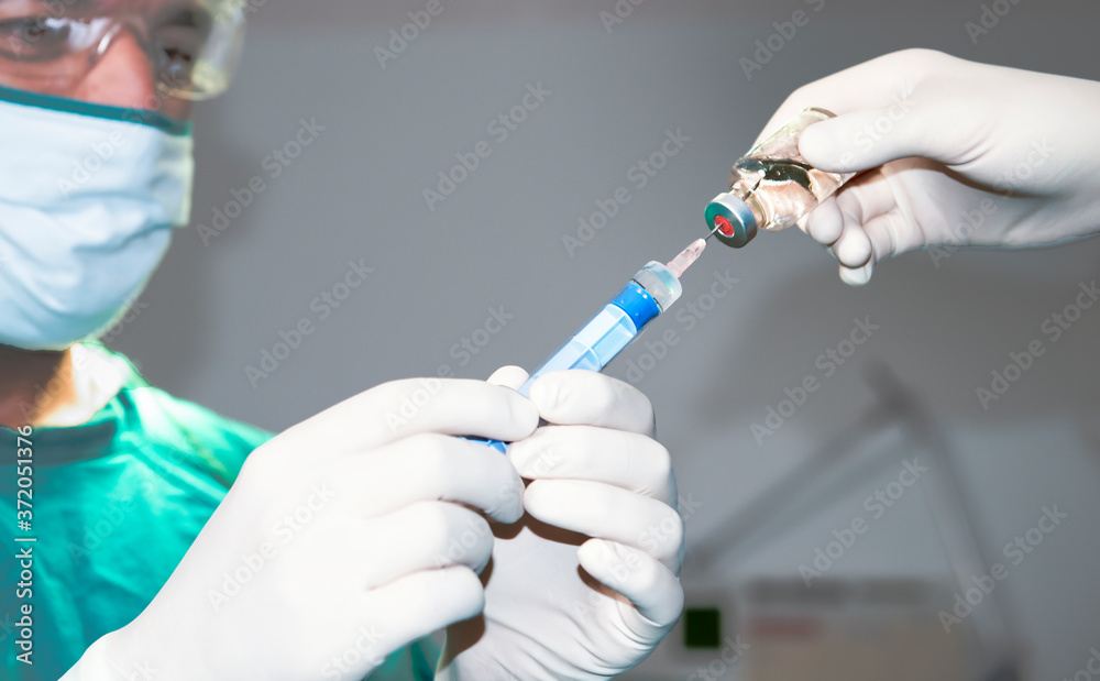 Senior anesthesiologist or doctor hold syringe prepare for injection in