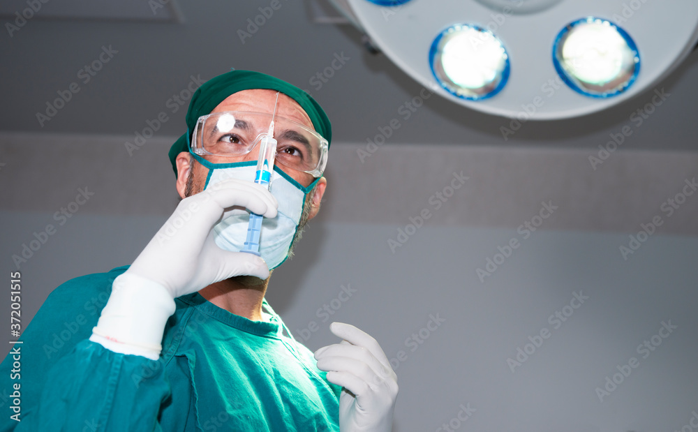 Senior anesthesiologist or doctor hold syringe prepare for injection in