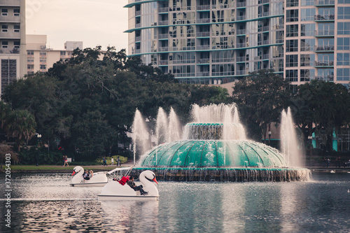 The lake cola fountain in downtown orlando florida in central florida Lake Eola Park is located in the heart of Downtown Orlando, with a sidewalk that circles the lake .9 miles in length photo