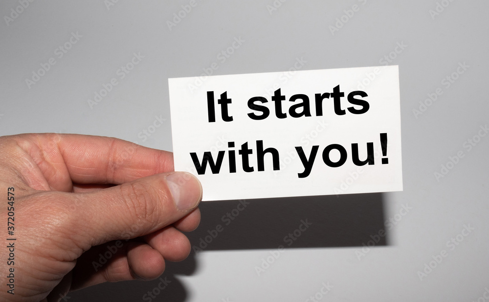 Message on the card IT STRATS WITH YOU, in hands of businessman. Message on the card IT STRATS WITH YOU, in hands of businessman.
