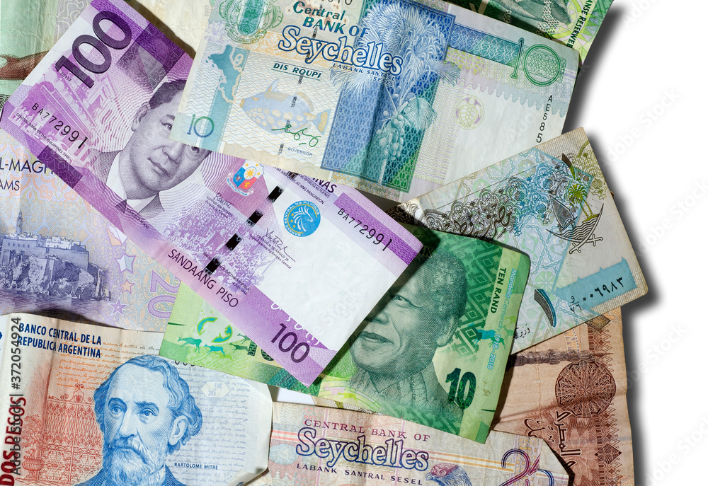 Obraz premium Banknotes of different countries over a white background