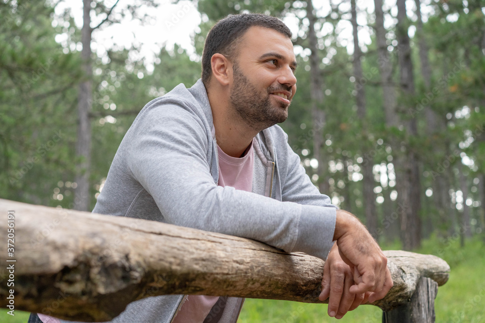 Young happy man relaxing in pine woods. Young happy man relaxing in pine woods.