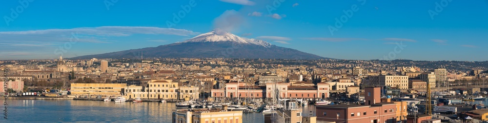 A view of Mount Etna Volcano over the harbour of Catania, Sicily, Italy