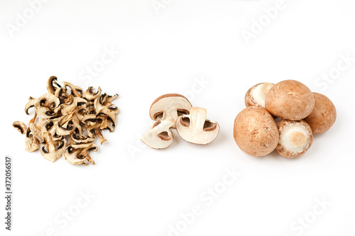 dehydrated dried mushroom slices and fresh mushrooms on a white background. Vegan and vegetarian food. photo