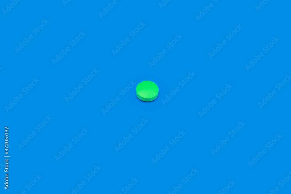 Green pill on blue background. Bright pill on indigo background. Blue seamless pattern and green pill. Green pill on blue background. Bright pill on indigo background. Blue seamless pattern and green pill.