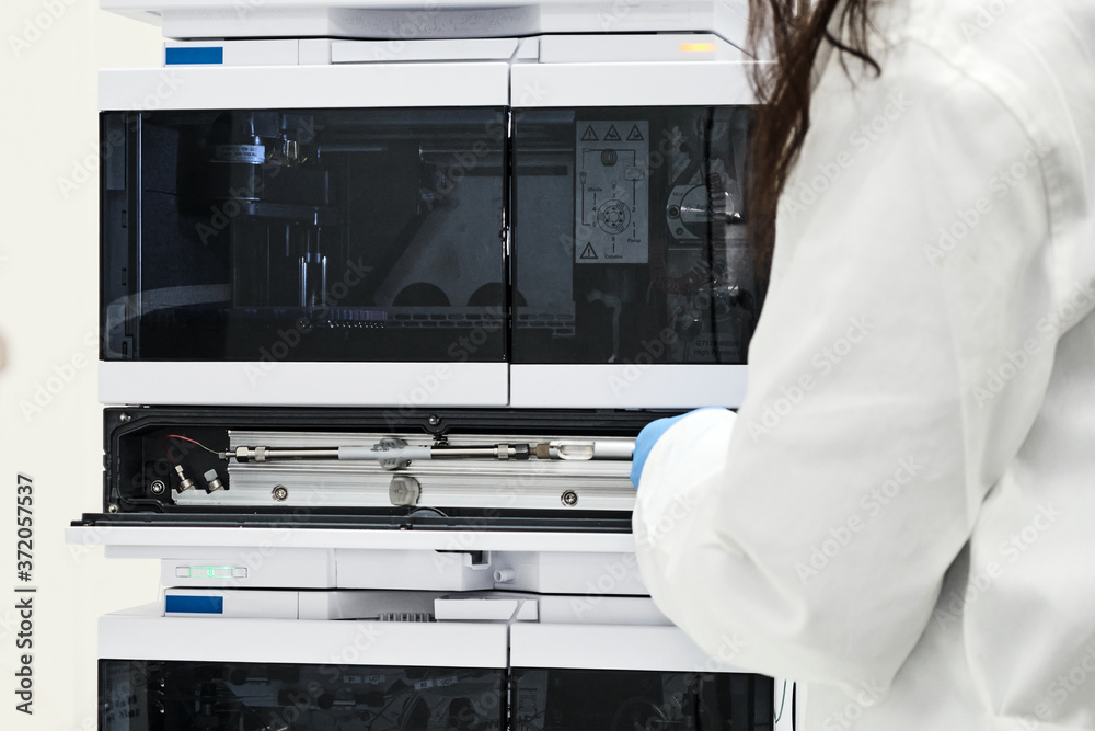 Chemist or scientist changing a column on high performance liquid