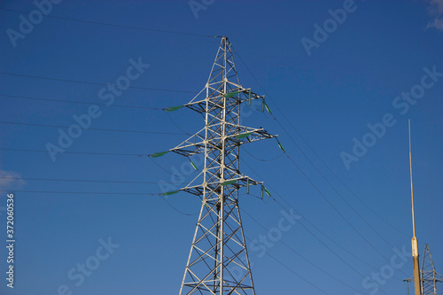 
Large 10,000 megawatt electric transmission support with glass insulators and many wires photo