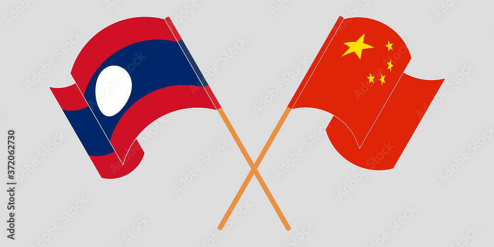 Crossed and waving flags of Laos and China Crossed and waving flags of Laos and China