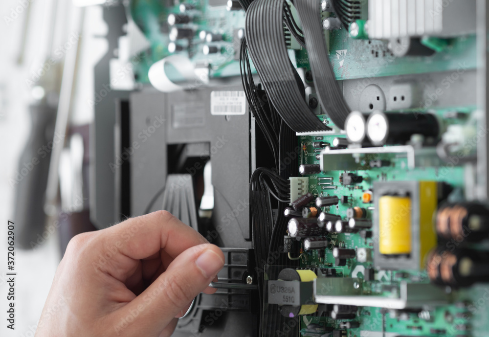 Hands with tools for repair computer. Blurred background. Hands with tools for repair computer. Blurred background.