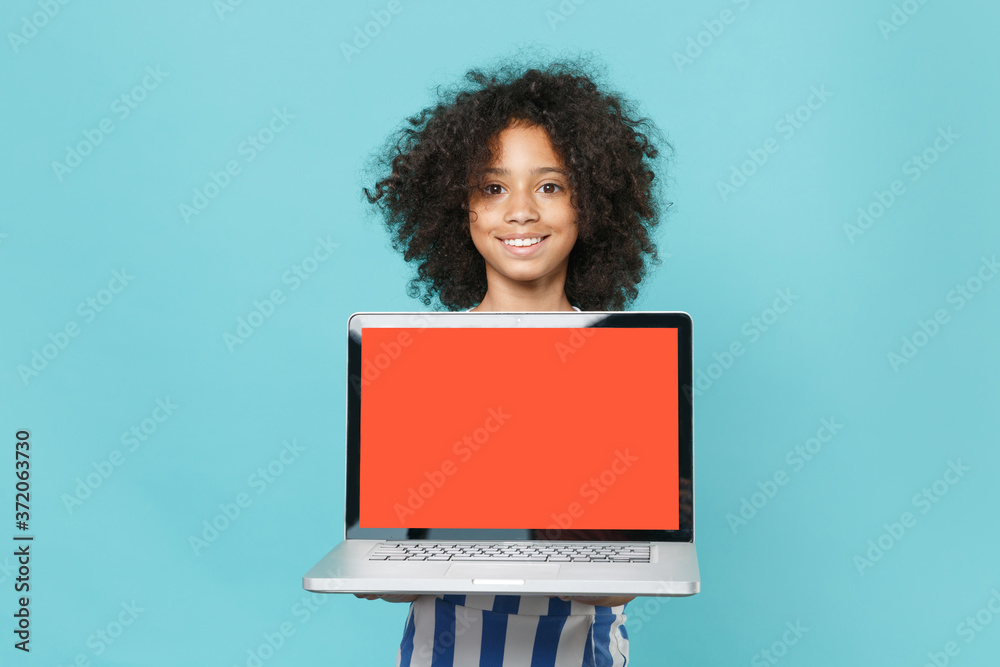 Smiling little african american kid girl 1213 years old in striped