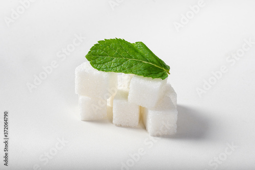 Refined sugar with mint on a white background. Set of mint and sugar.