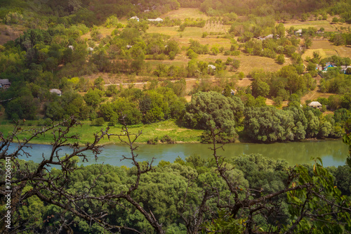 View of the river from a huge hill or mountain through the eyes of a hiker on a hike. Green forest nature background photo