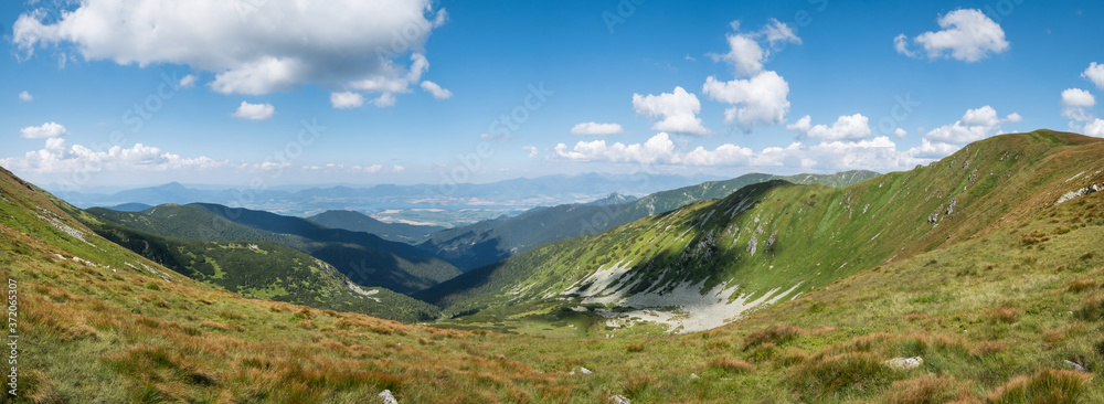 Panoramic spectacular view to Liptov region, High Tatras,Liptovska Mara lake in Slovakia from the range of Low Tatras (Nizke Tatry) Crest Trail. Popular trekking route through the whole mountain range