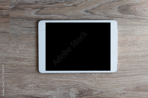 tablet pc on wooden  background