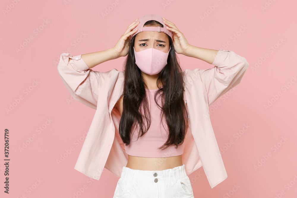 Preoccupied young asian woman girl in casual clothes cap face mask isolated on pastel pink wall background. Epidemic pandemic coronavirus 2019-ncov sars covid-19 flu virus concept. Put hands on head. Preoccupied young asian woman girl in casual clothes cap face mask isolated on pastel pink wall background. Epidemic pandemic coronavirus 2019-ncov sars covid-19 flu virus concept. Put hands on head.