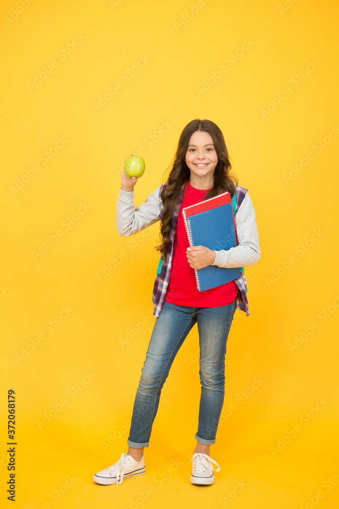 Healthy snack. Happy child hold apple and books. School snack. Snack break. Healthy eating and snacking. Vegetarian food. Vitamin nutrition. Diet and dieting. Breakfast or lunch time. Eat right Healthy snack. Happy child hold apple and books. School snack. Snack break. Healthy eating and snacking. Vegetarian food. Vitamin nutrition. Diet and dieting. Breakfast or lunch time. Eat right