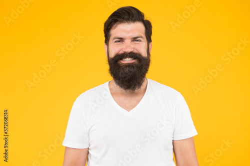 Bushy beard hipster man barbershop client yellow background, good looking guy concept