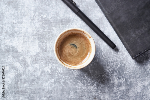 Cup of coffee on rustic wooden background. Top view. 