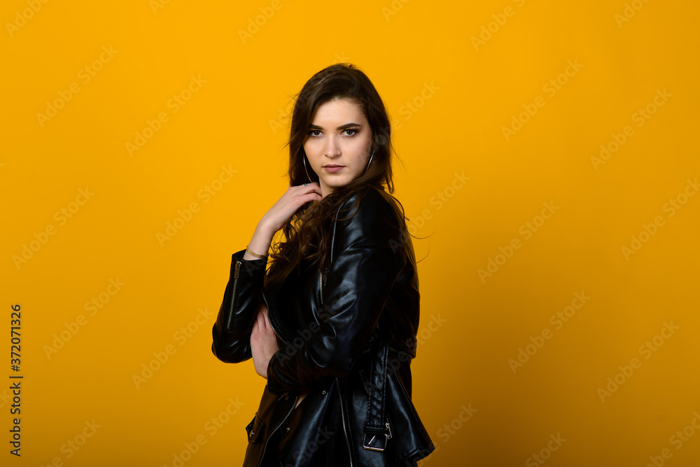 Portrait of a happy young brunette girl showing gestures and smiling, surprising isolated over yellow background. Emotional picture. Portrait of a happy young brunette girl showing gestures and smiling, surprising isolated over yellow background. Emotional picture.