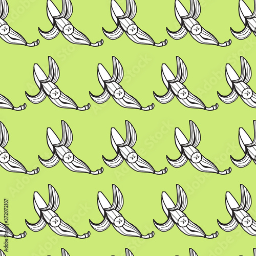 seamless pattern white bananas with a black outline on a light green background