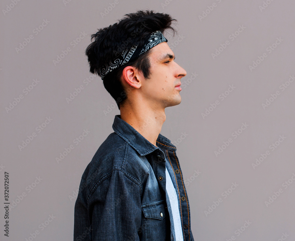 Side view of young man isolated on gray background Side view of young man isolated on gray background