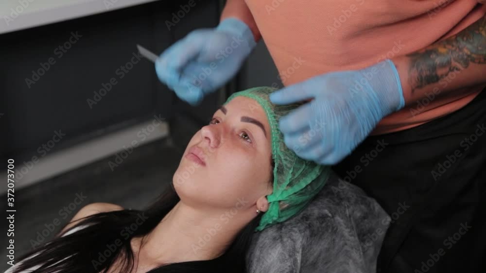 A pretty woman is marked out with permanent makeup areas. A pretty woman is marked out with permanent makeup areas.