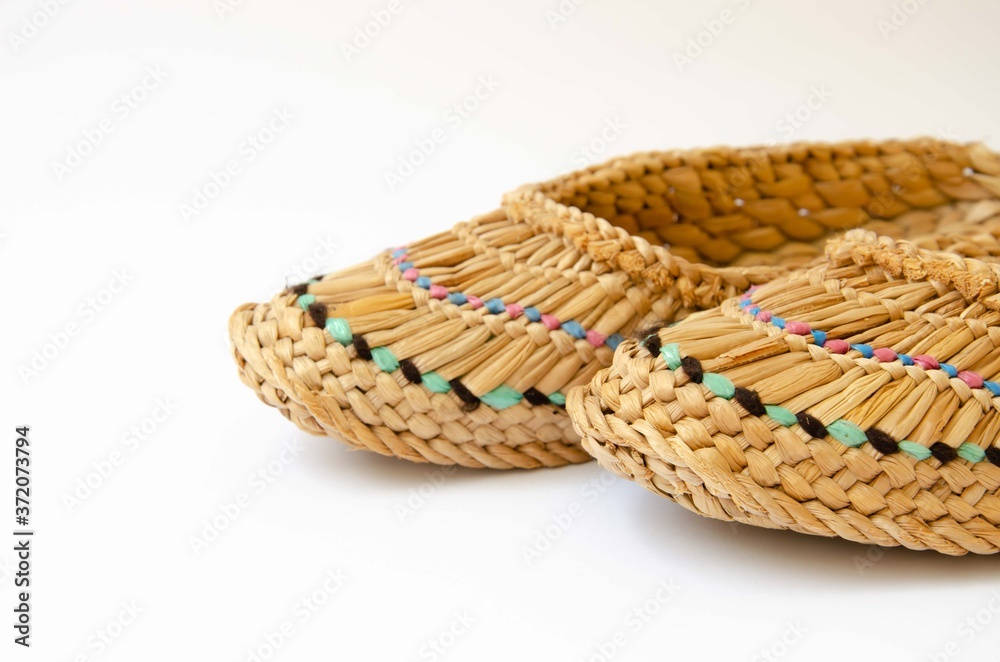 Straw slippers white background. Wicker slippers. Ancient home shoes white background.