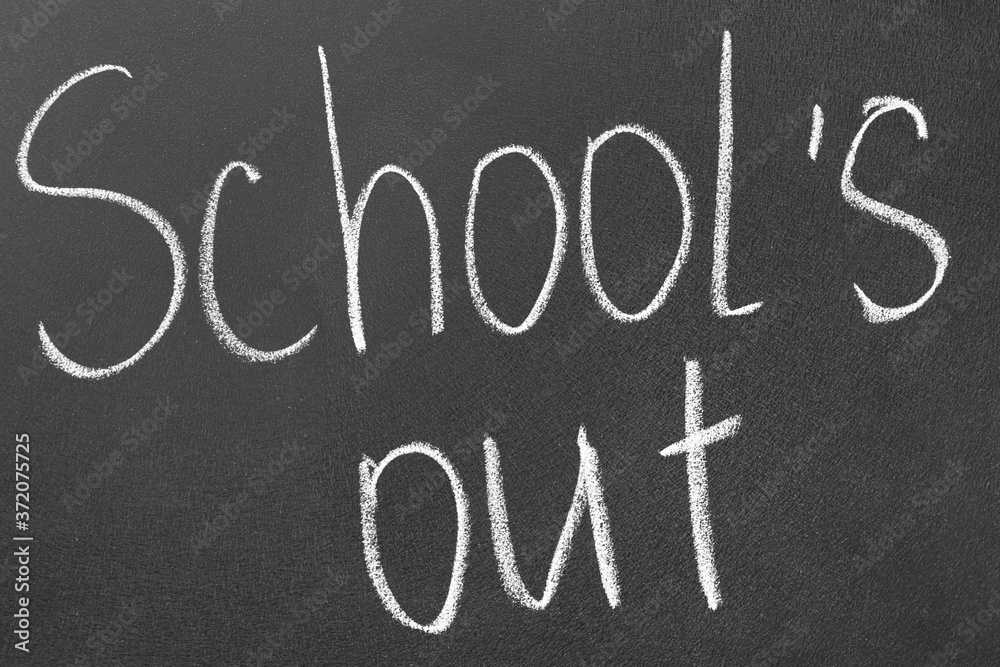 Fototapeta premium Words School's Out on blackboard. Summer holidays