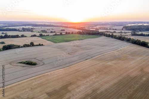 a farming landscape from above with evening glow