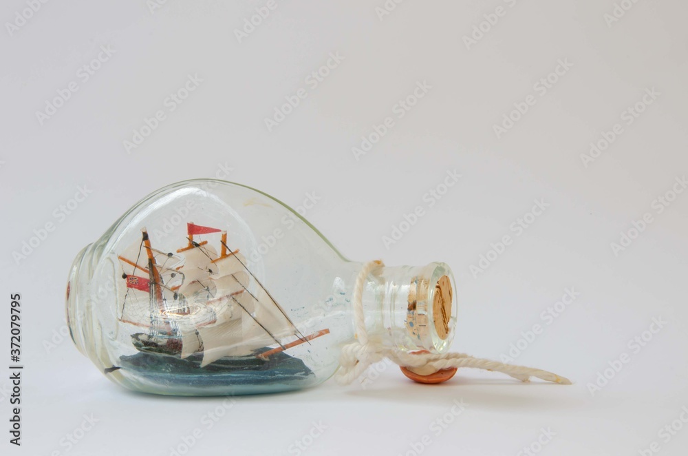 Ship in a bottle. Glass sailing ship background.