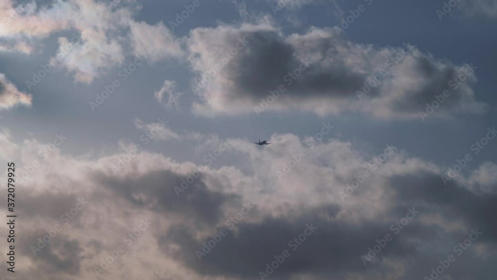 Plane is flying in sunset sky with clouds. Travel, vacation, air transport, transportation concept Plane is flying in sunset sky with clouds. Travel, vacation, air transport, transportation concept