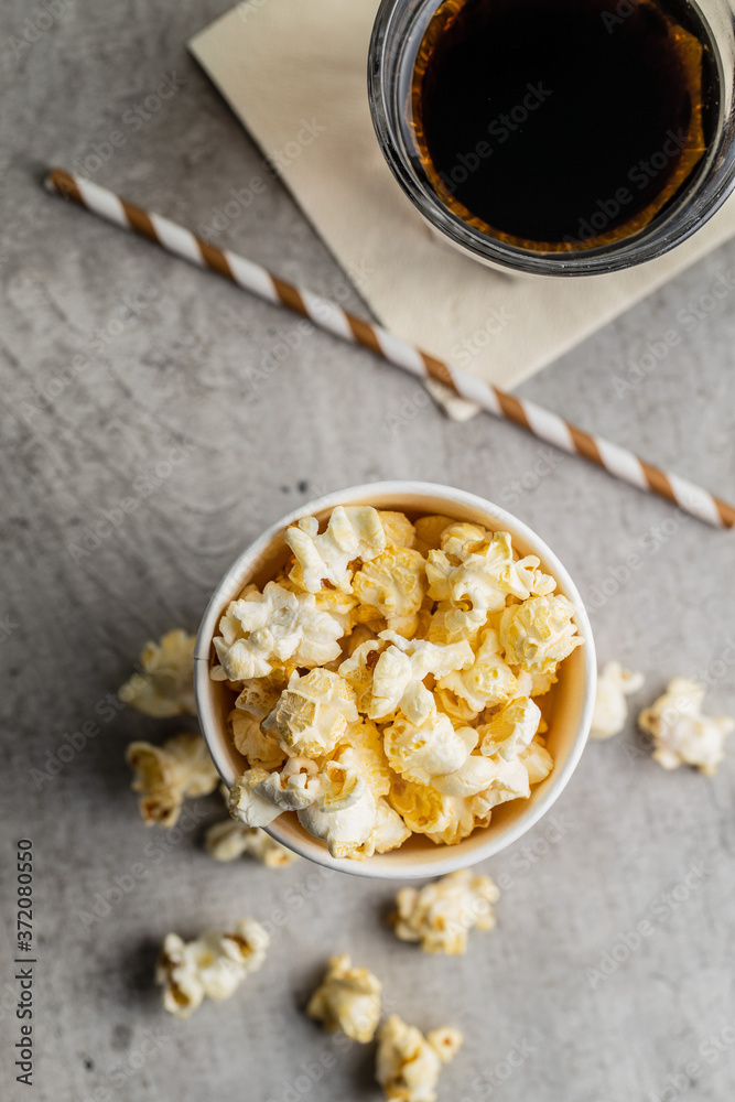 Fototapeta premium Sweet tasty popcorn in cup and glass of cola.