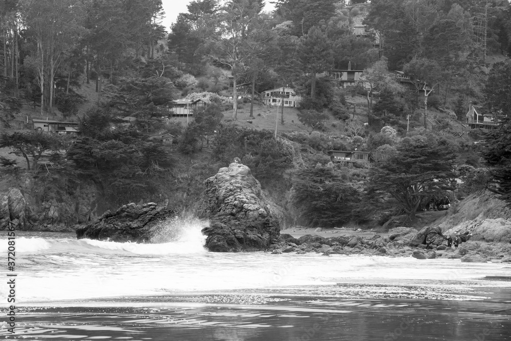 Ocean waves on a rocky shore in black and white