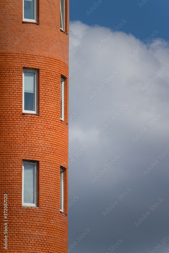 Close-up of architectural details and window of an old building against the blue sky, background or concept Close-up of architectural details and window of an old building against the blue sky, background or concept