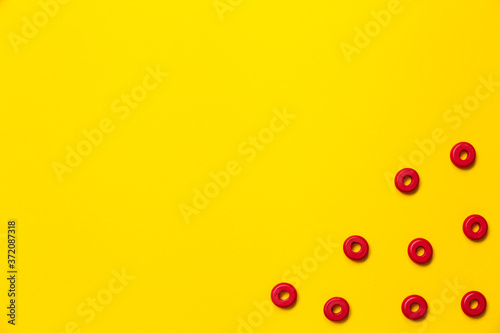 On a yellow background, there are rings of red color of the same size, which form a frame on children's education and development. Backdrop for placing text and other information