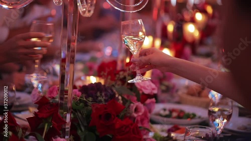 People clinking glasses at party. celebration on event. Festive table in a restaurant, people have dinner.