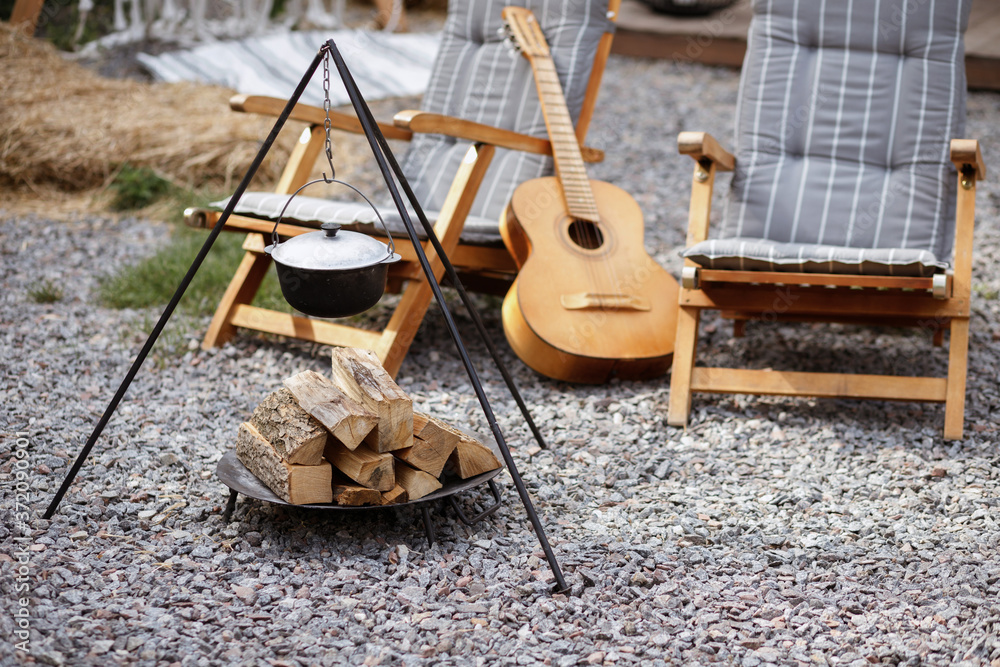 place for a campfire in the garden with a guitar in the background