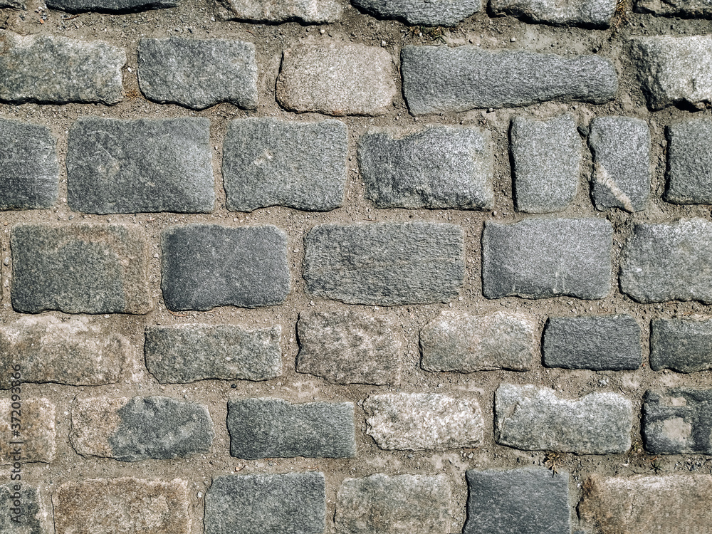 Texture of gray granite paving stones, top view. Background from natural block stone. Texture of gray granite paving stones, top view. Background from natural block stone.