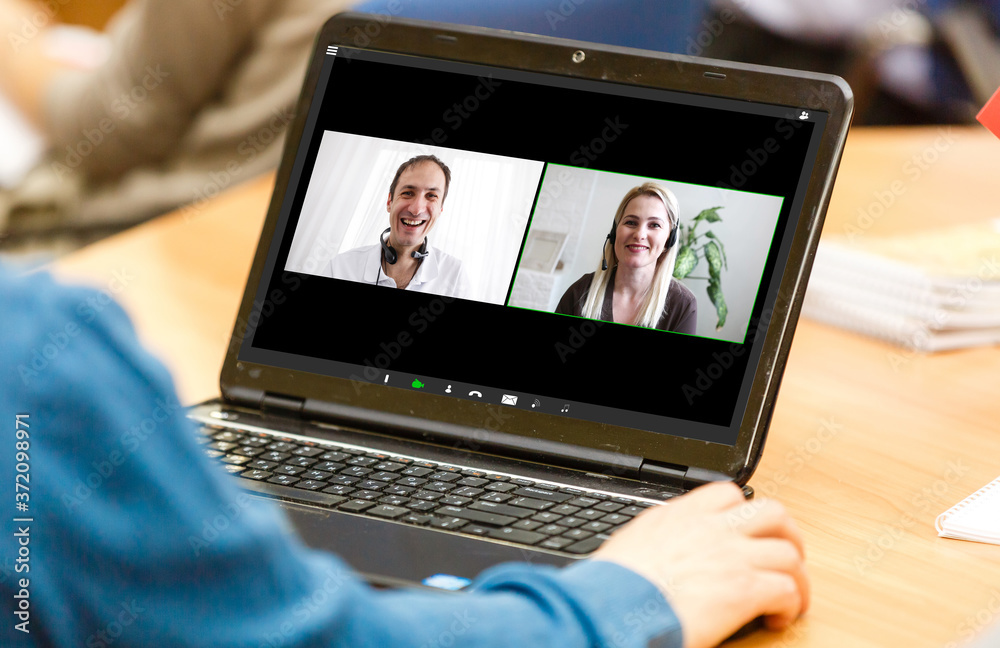 Man having video conference with friends on laptop at home Man having video conference with friends on laptop at home