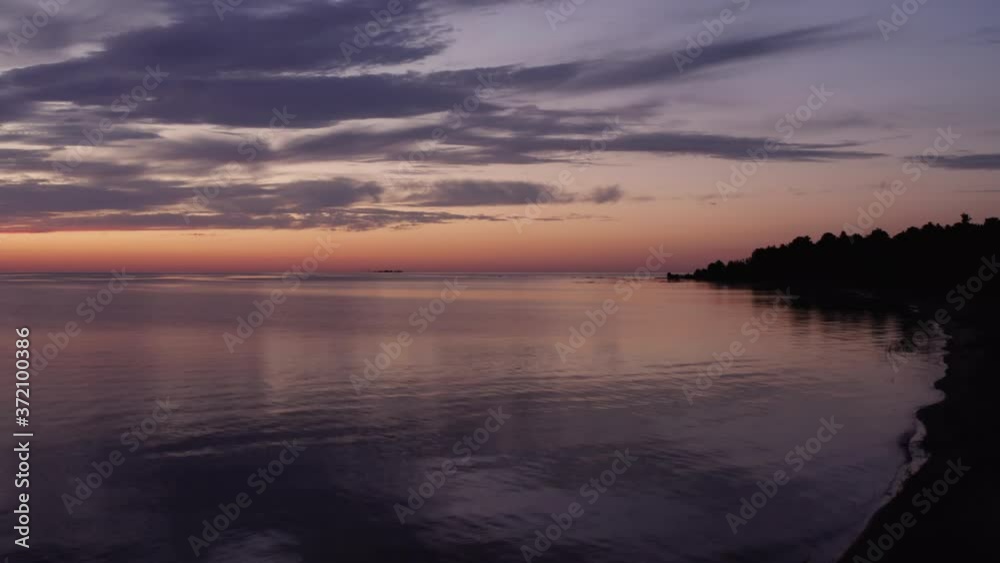 Rising over Great Lakes Coast at Pretty Sunrise, Tree in Foreground Drone Aerial Rising over Great Lakes Coast at Pretty Sunrise, Tree in Foreground Drone Aerial