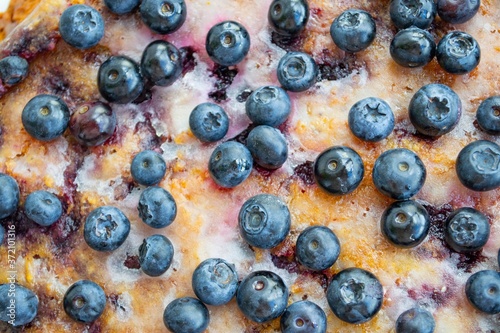 Large homemade pie with blackcurrant close-up  not all berries are specially focused   in natural daylight