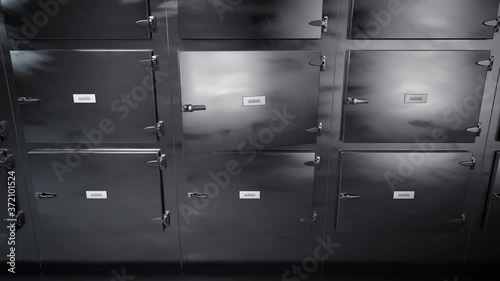 Dead body slide into mortuary refrigeraor for later autopsy, corpse on metal tray covered with white cloth, sliding into morgue freezer waiting for dissection. Front closeup view. photo