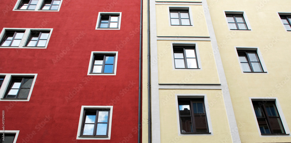 Colorful building facade with windows. Bicolor architecture in Munich